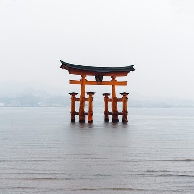 The Torii Gate standing in the water near the island of miyajima in Japan.